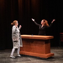 Two actors performing onstage.