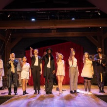 The cast of "The Wild Party" at Eagle Theatre points at the band to take a bow