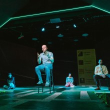Performance where neon lights line the stage in The Eagle Theatre