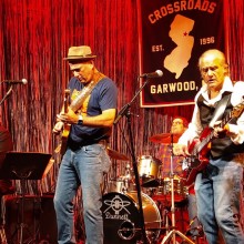 Men on stage with guitars and drums