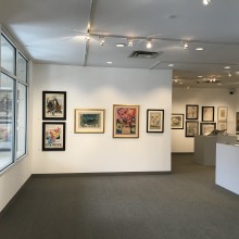 An art gallery with art work covering all of the walls.