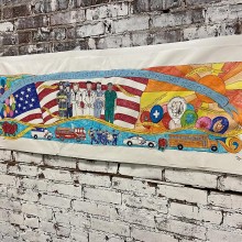 Artwork on a white brick wall.