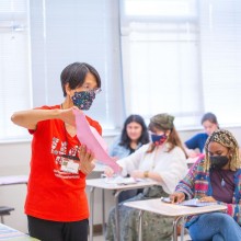 Teacher demonstrating before a class of students.