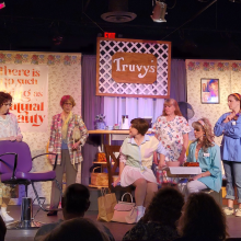 A group of women on stage of a set for "Steel Magnolias"