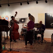 A group of musicians performing at an art gallery