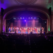 Cast of characters on stage.