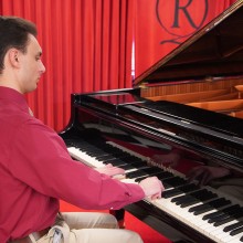 Student sitting at a piano