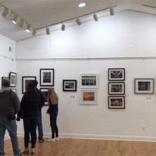 People viewing art on the walls of the Ocean County Artists Guild