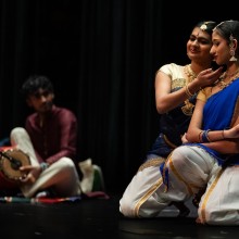 three youth on stage in Indian attire