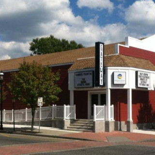 Exterior of the Gateway Playhouse, a red building with white trim and marquee signage on a sunny day.