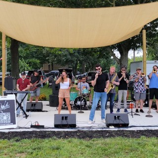 a band performs on an outdoor stage