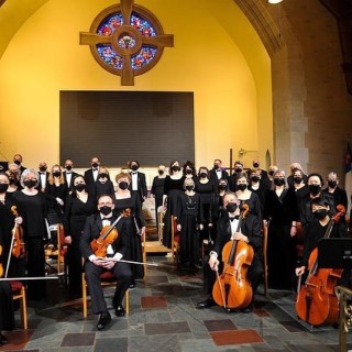 orchestra performing in black tie attire