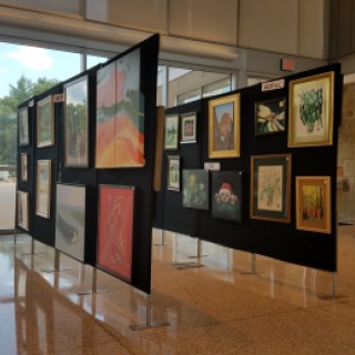 Senior art show displayed on boards in the Essex County Robert J. O'Toole Community Center