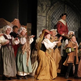 A full cast scene from a children’s musical performance of Cinderella