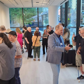 Crowd of people looking at art in a gallery