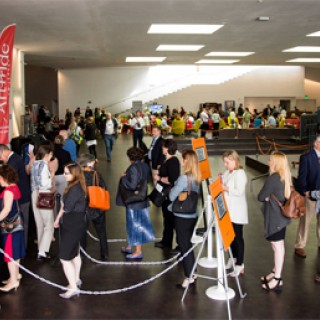 a group waits in line at a table with a large red sign that says ArtPride New Jersey