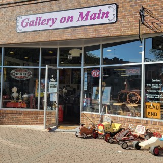 The storefront of Gallery on Main, a brick building with large windows