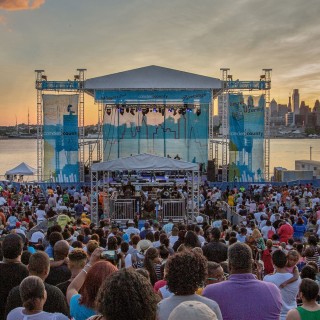 A large crowd at an outdoor music festival along the Camden Waterfront