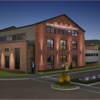 a rendering of an exterior image of the large brick building with a white sign that says “The Avenel Performing Arts Center