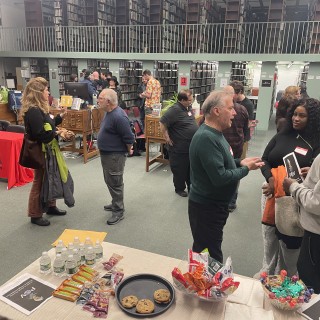 Group standing for networking at a Filmmaker Meetup at the public library