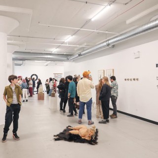A group of people standing in front of a collection of sculptures