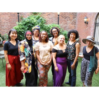a diverse group of women smiling for a photo together