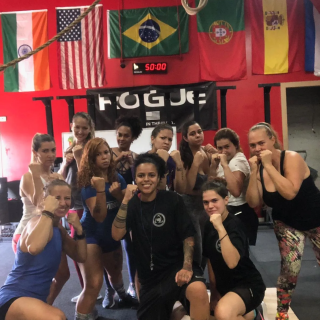 women posing with their fists up after a self-defense class