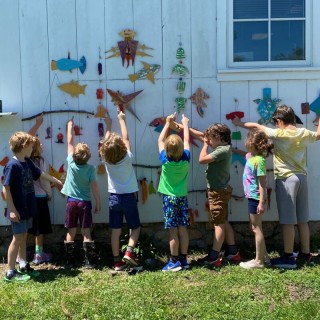 outdoor child's art class enjoy looking at their work