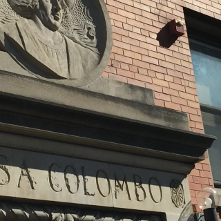 The facade of a building with the words “Casa Colombo” carved into it