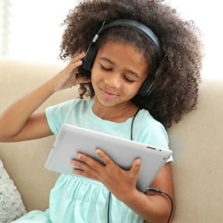 A child listening to headphones