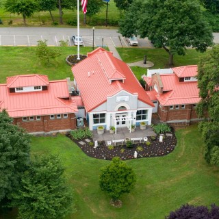 An aerial view of a red roofed building
