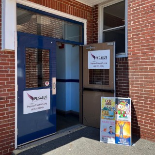 Pegasus Theatre exterior door near brick wall