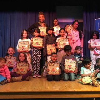 Small children onstage holding books at Winceyco