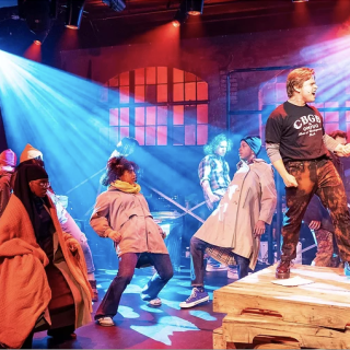 Actors onstage peforming at Vanguard Theater Company
