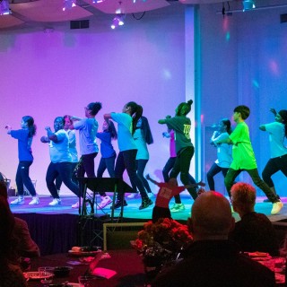 Children performing on a brightly colored stage