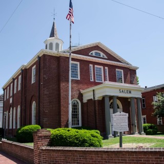 A brick building is red with the word Salem written on it.