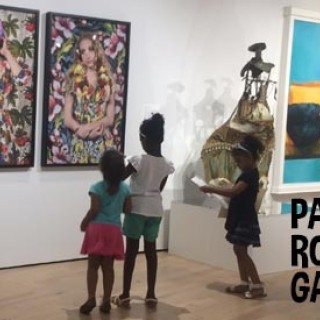 Kids viewing artwork on the walls of a gallery