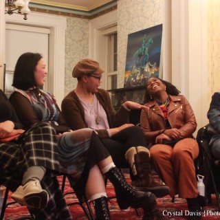 Deonté Griffin Quick and others sit laughing at a reading.