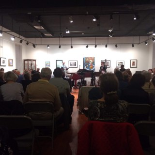 A group of people attending a concert in an art gallery