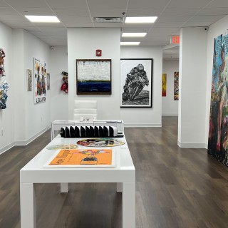 Interior of the RAM Gallery with white walls and hardwood floors