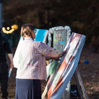 Woman painting a canvas outdoors