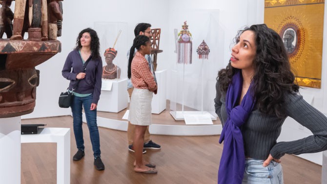 four people in a museum exhibit