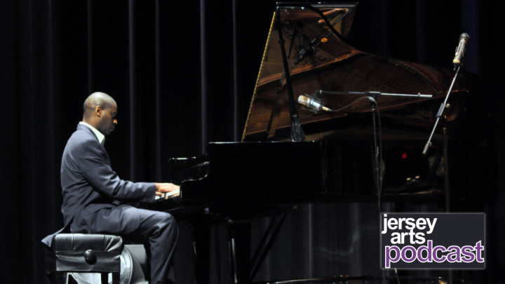 James Austin Jr. sits at a grand piano playing music