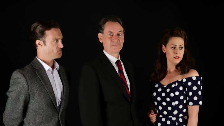 Three actors standing side-by-side with a black background