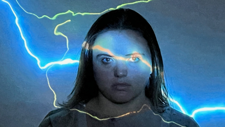 A woman with lightning projected across her face