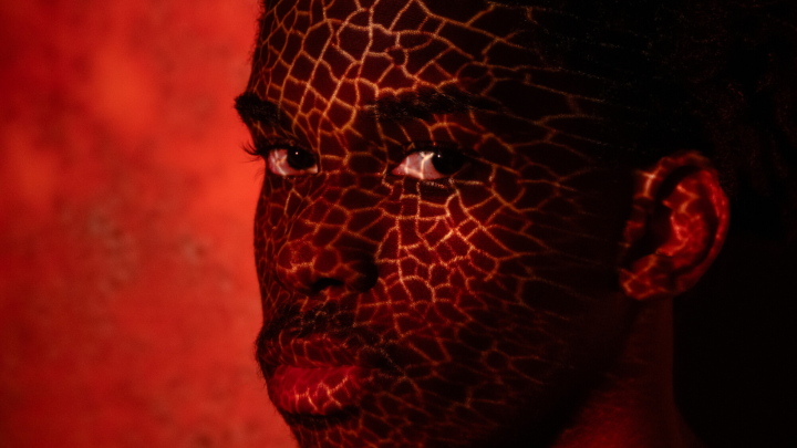 Man in red paint looking at the camera