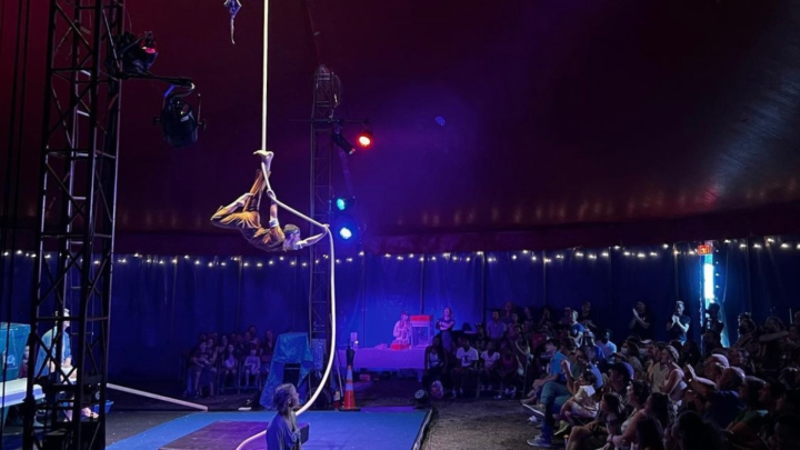Performer suspended by rope