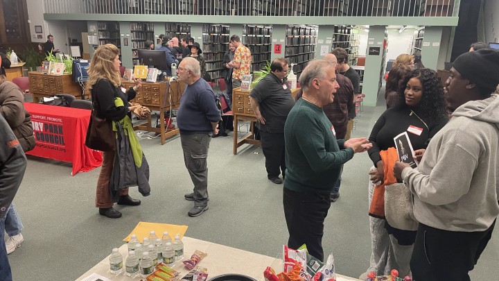 Group standing for networking at a Filmmaker Meetup at the public library