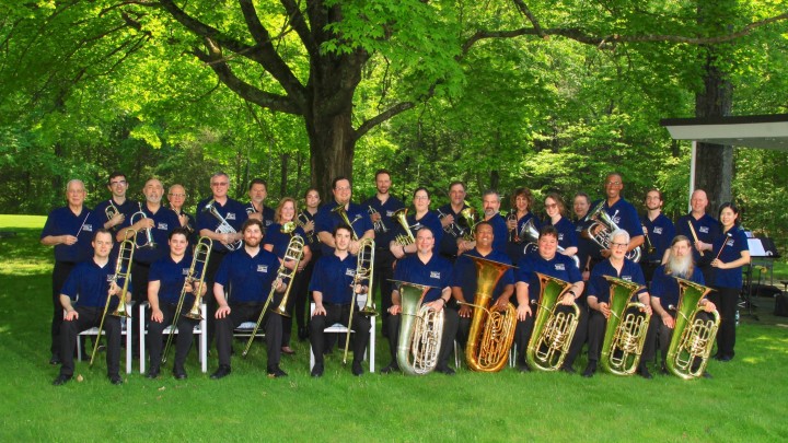 a group photo of the Imperial Brass musicians with their respective brass instruments