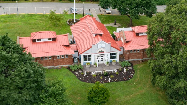 An aerial view of a red roofed building
